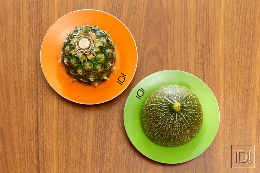 Pineapple and melon sliced on a coloured plate.